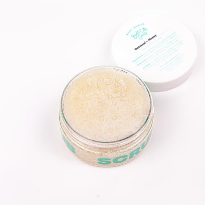 open container of Oatmeal + Honey Body Scrub with lid placed next to it